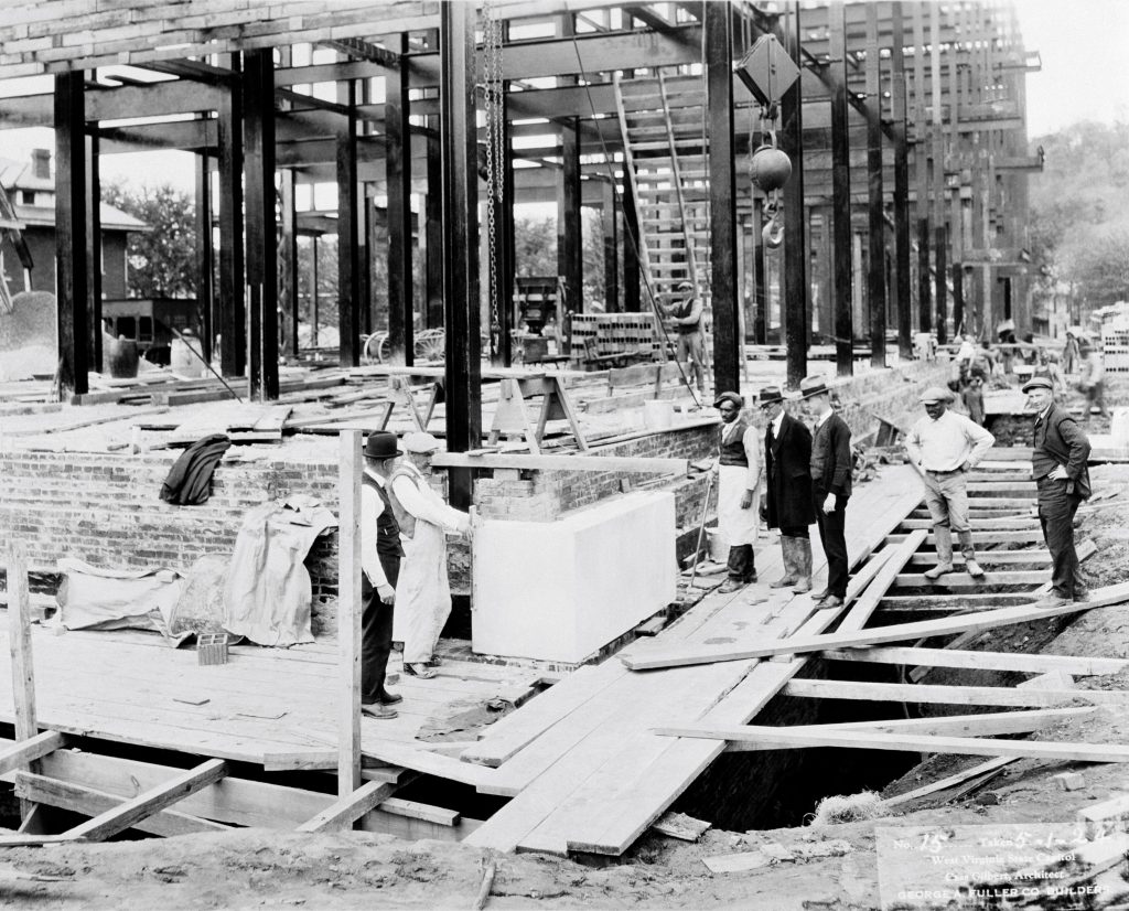 Construction workers lay cornerstones of West Wing of the Capitol Complex.